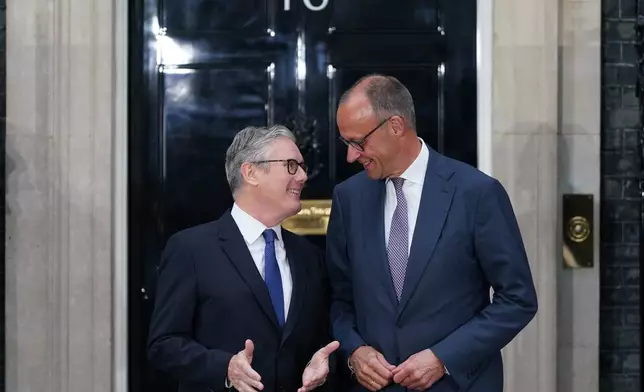 Britain's Prime Minister, Keir Starmer, left, greets the German Chancellor, Friedrich Merz on the doorstep of 10 Downing Street ahead of a meeting inside, in London, Sunday, June 7, 2026. (AP Photo/Alberto Pezzali)