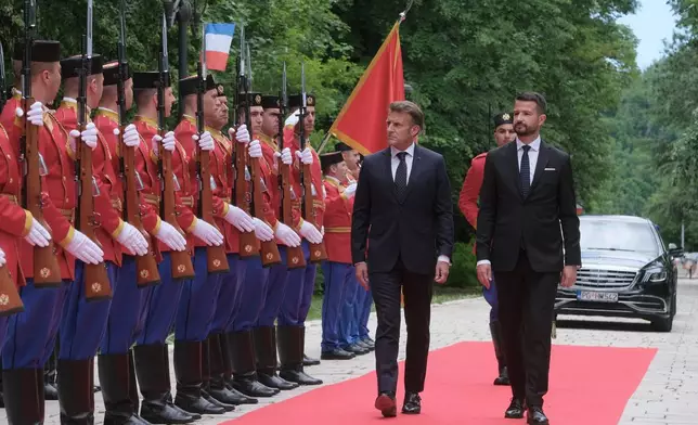 French President Emmanuel Macron, left, reviews the honor guard with Montenegro's President Jakov Milatovic during a welcome ceremony in Cetinje, Montenegro, Thursday, June 4, 2026. (AP Photo/Risto Bozovic)