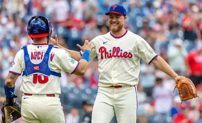 Philadelphia Phillies closing pitcher Jonathan Bowlan, right, and catcher Rafael Marchán, left, celebrate after their team's win over the Chicago White Sox in a baseball game, Sunday, June 7, 2026, in Philadelphia. (AP Photo/Laurence Kesterson)