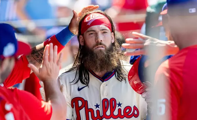 Philadelphia Phillies' Brandon Marsh is cheered in the dugout after hitting a solo home run in the third inning of a baseball game against the Chicago White Sox, Sunday, June 7, 2026, in Philadelphia. (AP Photo/Laurence Kesterson)