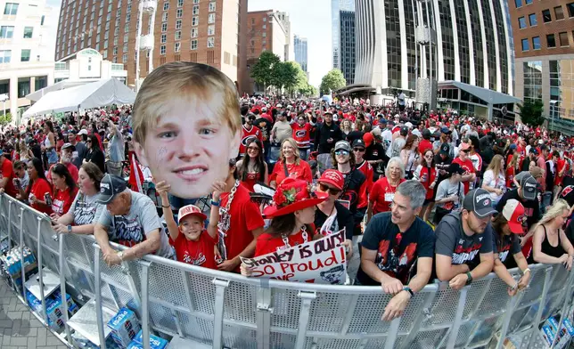 Carolina Hurricanes fans crowd onto Fayetteville Street prior to the start of the Stanley Cup Championship celebration in Raleigh, N.C., Saturday, June 20, 2026. (AP Photo/Karl DeBlaker)