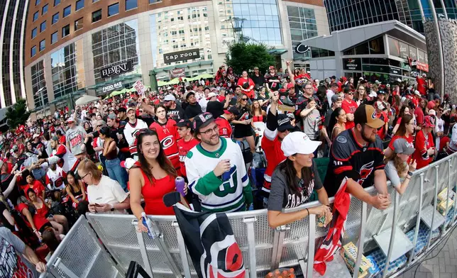 Carolina Hurricanes fans crowd onto Fayetteville Street prior to the start of the Stanley Cup Championship celebration in Raleigh, N.C., Saturday, June 20, 2026. (AP Photo/Karl DeBlaker)