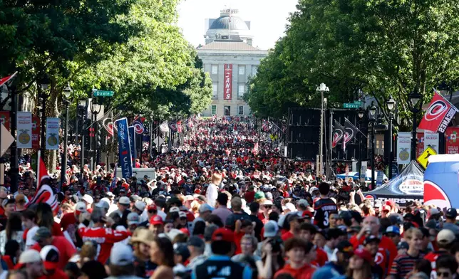 Carolina Hurricanes fans crowd onto Fayetteville Street prior to the start of the Stanley Cup Championship celebration in Raleigh, N.C., Saturday, June 20, 2026. (AP Photo/Karl DeBlaker)