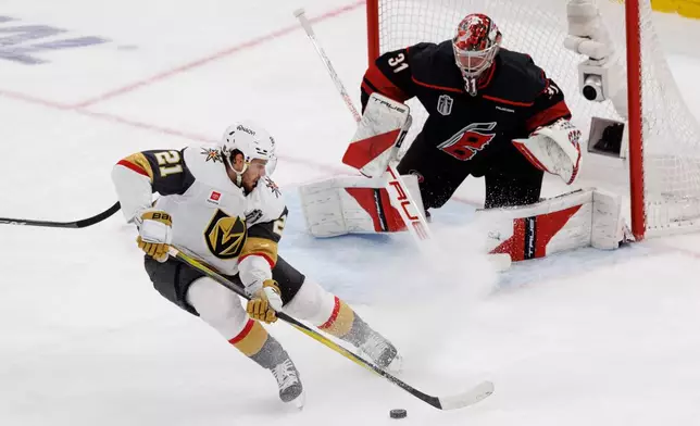 Vegas Golden Knights' Brett Howden (21) handles the puck in front of Carolina Hurricanes goaltender Frederik Andersen (31) during the second period of Game 2 of the NHL hockey Stanley Cup Final series in Raleigh, N.C., Thursday, June 4, 2026. (AP Photo/Ben McKeown)