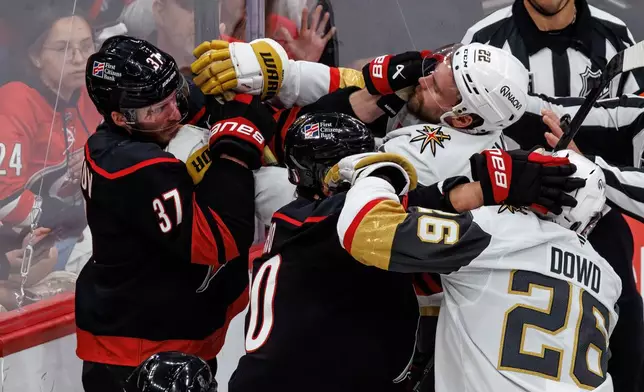 Carolina Hurricanes' Andrei Svechnikov (37) and Sebastian Aho (20) scuffle with Vegas Golden Knights' Cole Smith (22) and Nic Dowd (26) during the second period of Game 2 of the NHL hockey Stanley Cup Final series in Raleigh, N.C., Thursday, June 4, 2026. (AP Photo/Ben McKeown)