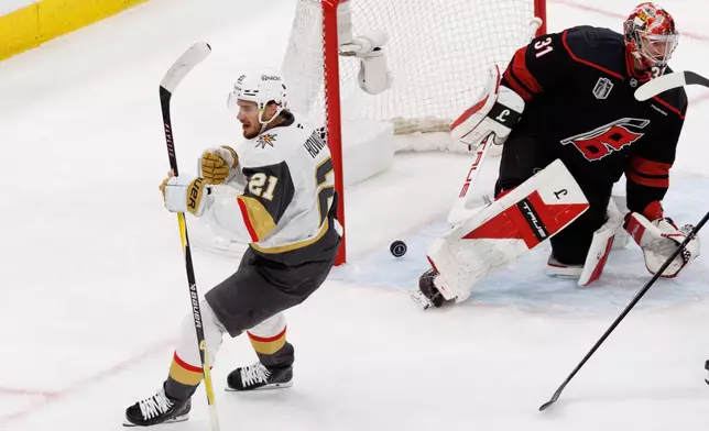 Vegas Golden Knights' Brett Howden (21) reacts ahead of Carolina Hurricanes' goaltender Frederik Andersen (31) after scoring a goal during the first period of Game 2 of the NHL hockey Stanley Cup Final series in Raleigh, N.C., Thursday, June 4, 2026. (AP Photo/Ben McKeown)