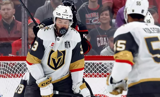 Vegas Golden Knights' Brayden McNabb takes a puck to the face during the first period in Game 2 of the NHL hockey Stanley Cup Final series against the Carolina Hurricanes in Raleigh, N.C., Thursday, June 4, 2026. (AP Photo/Karl DeBlaker)