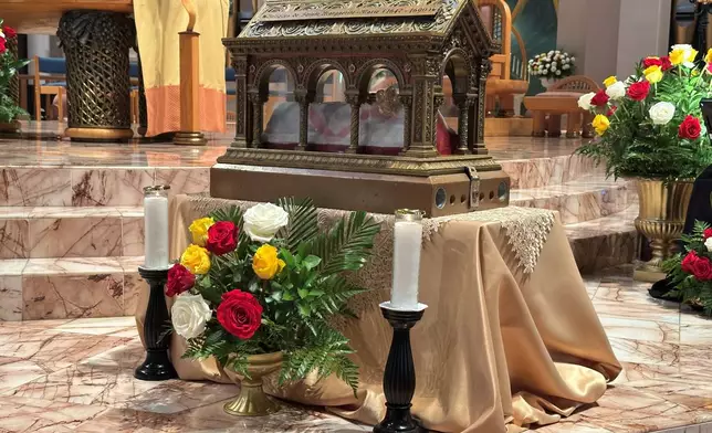 A box containing relics of the 17th century St. Mary Margaret Alacoque, a French nun whose reports of visions of Jesus has led to the modern devotion of the Sacred Heart of Jesus, stands Thursday in front of the Basilica of the National Shrine of Mary, Queen of the Universe in Orlando, Fla., before a service in which U.S. Catholic bishops consecrated the United States to the Sacred Heart upon the nation's 250th anniversary. (AP Photo/Peter Smith)