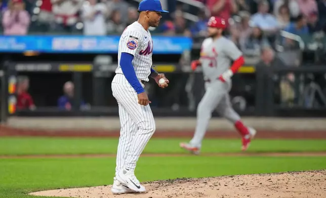 New York Mets pitcher Freddy Peralta reacts as St. Louis Cardinals' Alec Burleson runs the bases after hitting a two-run home run during the fifth inning of a baseball game Tuesday, June 9, 2026, in New York. (AP Photo/Frank Franklin II)