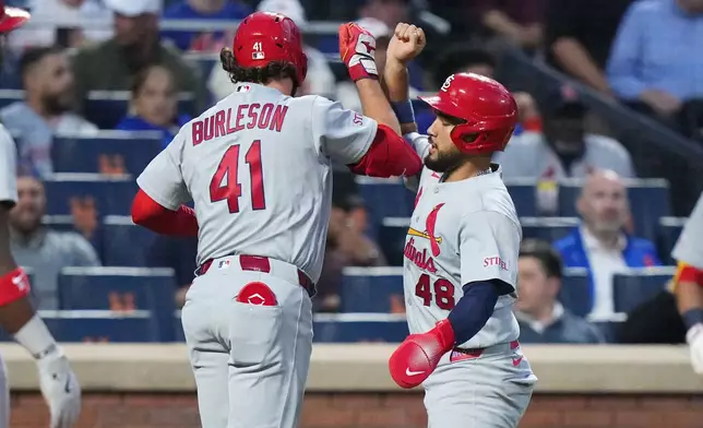 St. Louis Cardinals' Iván Herrera (48) celebrates with Alec Burleson (41) after they scored on a two-run home run by Burleson during the fifth inning of a baseball game against the New York Mets Tuesday, June 9, 2026, in New York. (AP Photo/Frank Franklin II)