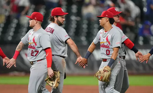 St. Louis Cardinals' Alec Burleson, center, Masyn Winn, right, and Nathan Church, right, celebrates with teammates after a baseball game against the New York Mets Tuesday, June 9, 2026, in New York. (AP Photo/Frank Franklin II)