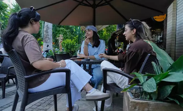 Women sit in the al fresco dining area of a cafe in northern Tehran, Wednesday, June 10, 2026. (AP Photo/Vahid Salemi)