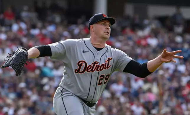 Detroit Tigers starting pitcher Tarik Skubal tosses the ball to first base but not in time to get Cleveland Guardians' Stuart Fairchild out during the fourth inning of a baseball game, Saturday, June 13, 2026, in Cleveland. (AP Photo/Phil Long)