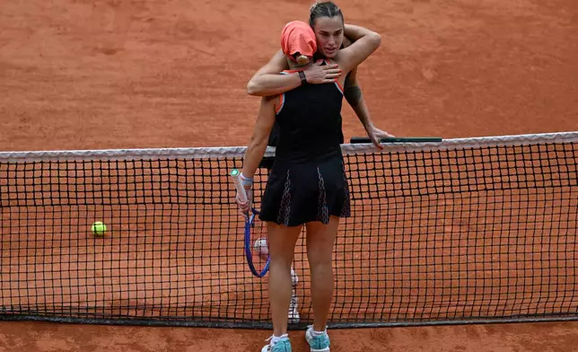 Aryna Sabalenka of Belarus hugs Russia's Diana Shnaider after the quarterfinal tennis match at the French Open in Paris, Wednesday, June 3, 2026. (AP Photo/Emma Da Silva)