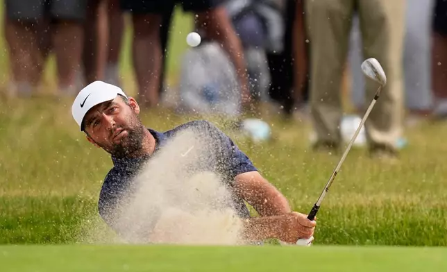 Scottie Scheffler hits from the bunker on the 13th hole during the second round of the U.S. Open golf tournament at Shinnecock Hills Golf Club in Southampton, N.Y., Friday, June 19, 2026.(AP Photo/David J. Phillip)