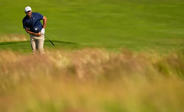 Scottie Scheffler hits from the fairway on the first hole during the second round of the U.S. Open golf tournament at Shinnecock Hills Golf Club in Southampton, N.Y., Friday, June 19, 2026.(AP Photo/George Walker IV)