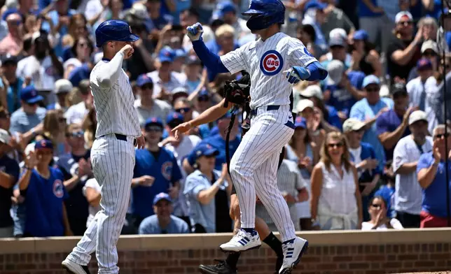 Chicago Cubs' Matt Shaw, right, high-fives Alex Bregman after Shaw's three-run home run during the second inning of a baseball game against the Toronto Blue Jays, Saturday, June 20, 2026, in Chicago. (AP Photo/Matt Marton)