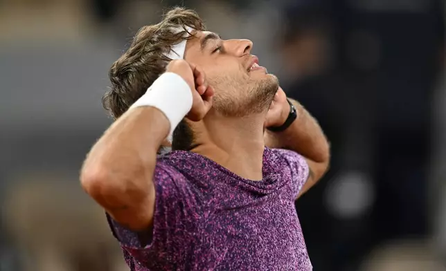 Italy's Flavio Cobolli reacts after winning the quarterfinal tennis match against Canada's Felix Auger-Aliassime at the French Open in Paris, Wednesday, June 3, 2026. (AP Photo/Emma Da Silva)