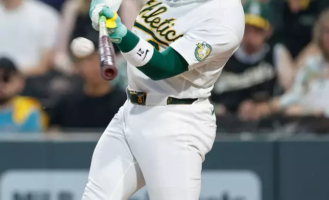 Athletics designated hitter Carlos Cortes hits a solo home run during the seventh inning of a baseball game against the Milwaukee Brewers, Wednesday, June 10, 2026, in Las Vegas. (AP Photo/Caroline Brehman)