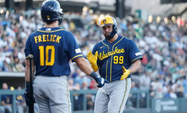 Milwaukee Brewers' Gary Sanchez (99) is greeted by Milwaukee Brewers' Sal Frelick (10) after hitting a solo home run during the second inning of a baseball game against the Athletics, Wednesday, June 10, 2026, in Las Vegas. (AP Photo/Caroline Brehman)
