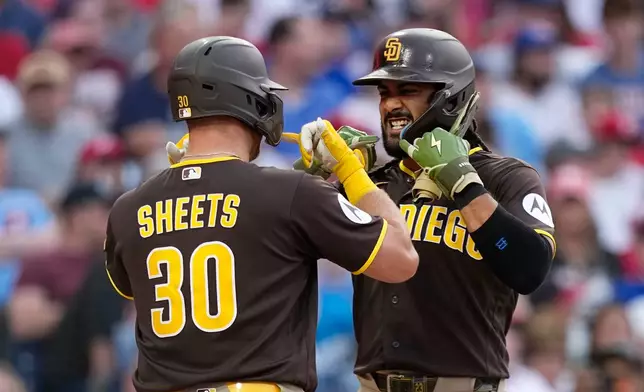 San Diego Padres' Fernando Tatis Jr., right, and Gavin Sheets celebrate after Sheets' two-run home run against Philadelphia Phillies pitcher Aaron Nola during the third inning of a baseball game Tuesday, June 2, 2026, in Philadelphia. (AP Photo/Matt Slocum)