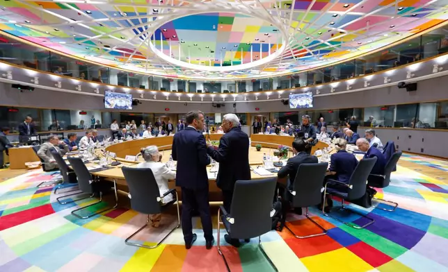 European Council President Antonio Costa, right, talks to French President Emmanuel Macron during a round table meeting at the EU summit in Brussels, Friday, June 19, 2026. (AP Photo/Geert Vanden Wijngaert)