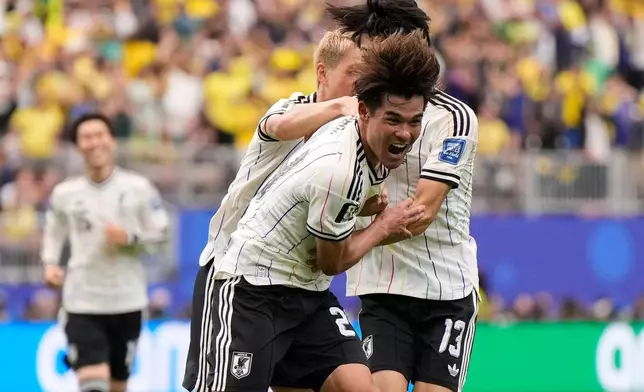 Japan's Kaishu Sano (24) celebrates after scoring the opening goal of his team during the World Cup round of 32 soccer match between Brazil and Japan in Houston, Monday, June 29, 2026. (AP Photo/Ashley Landis)