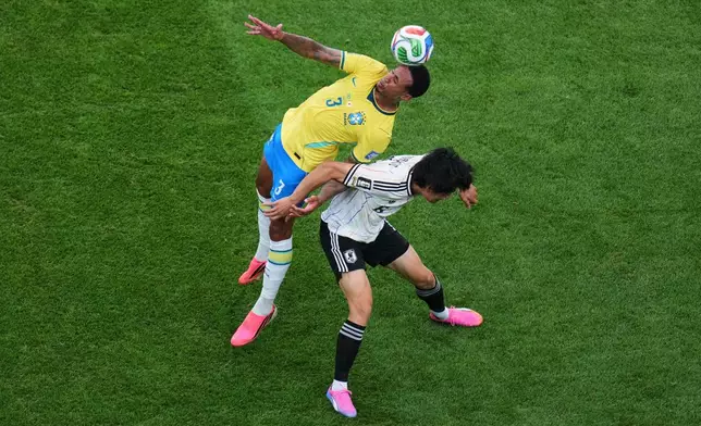 Brazil's Gabriel Magalhaes (3). left, heads for the ball with Japan's Wataru Endo (6) during the World Cup round of 32 soccer match between Brazil and Japan in Houston, Monday, June 29, 2026. (AP Photo/Eric Smith)