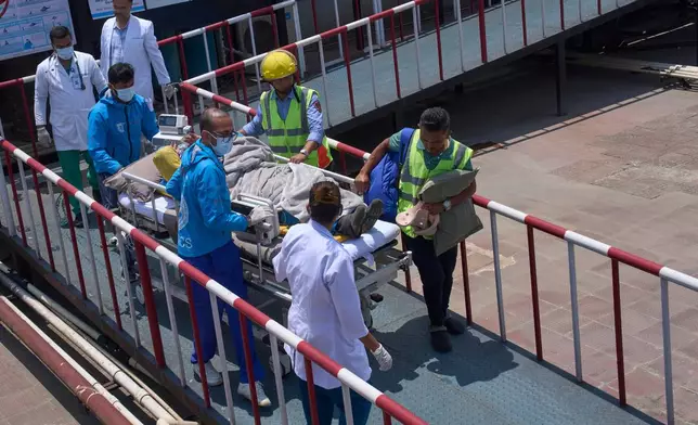 Medics take Dawa Sherpa, a mountain guide who had been missing for several days in the Everest region, for treatment after he arrived at HAMS Hospital in Kathmandu, Nepal, Thursday, June 4, 2026. (AP Photo/Niranjan Shrestha) CORRECTION: Corrects hospital name to HAMS not Grande