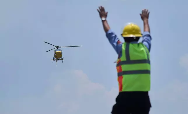 A helicopter carrying Dawa Sherpa, a mountain guide who had been missing for several days in the Everest region, arrives at Grande Hospital in Kathmandu, Nepal, Thursday, June 4, 2026. (AP Photo/Niranjan Shrestha)