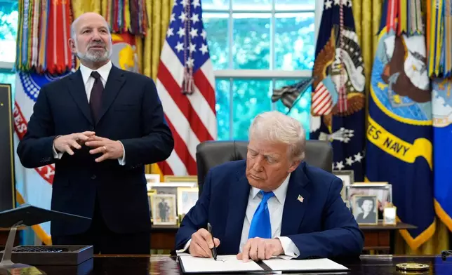 FILE - Commerce Secretary Howard Lutnick speaks as President Donald Trump signs the Gold Card executive order in the Oval Office of the White House, Sept. 19, 2025, in Washington. (AP Photo/Alex Brandon, File)