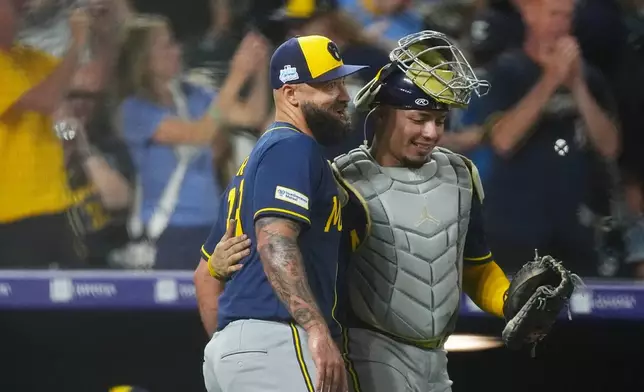 Milwaukee Brewers relief pitcher Drew Rom, left, congratulates catcher William Contreras after defeting the Colorado Rockies in a baseball game Saturday, June 6, 2026, in Denver. (AP Photo/David Zalubowski)