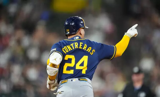 Milwaukee Brewers' William Contreras gestures to the bullpen as he rounds the bases after hitting a solo home run off Colorado Rockies relief pitcher Brennan Bernardino in the seventh inning of a baseball game Saturday, June 6, 2026, in Denver. (AP Photo/David Zalubowski)