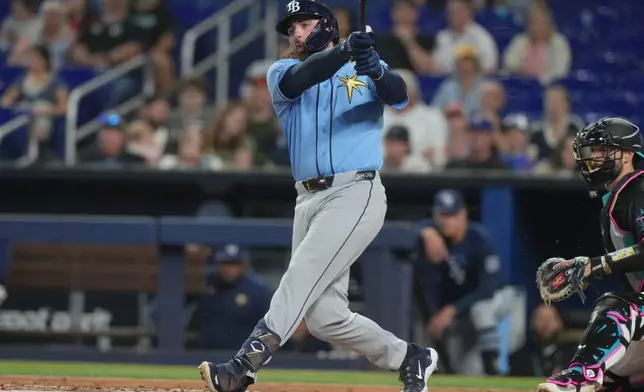Tampa Bay's Ryan Vilade hits a single during the first inning of a baseball game against the Miami Marlins Friday, June 5, 2026, in Miami. (AP Photo/Marta Lavandier)