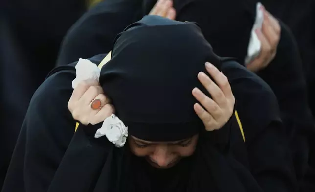 A woman mourns during a sermon marking the third day of Ashoura, the Shiite Muslim commemoration of the 7th-century death of Imam Hussein, the grandson of the Prophet Muhammad, in the southern port city of Tyre, Lebanon, Friday, June 19, 2026. (AP Photo/Hassan Ammar)