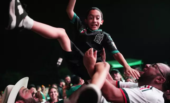 Fans celebrate in a fan zone in Monterrey, Mexico, after Mexico defeated South Korea in a World Cup Group A soccer match in Zapopan, Mexico, Thursday, June 18, 2026. (AP Photo/Matias Delacroix)