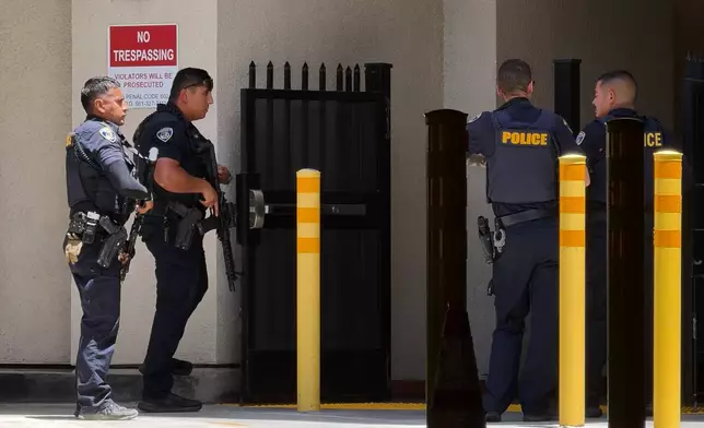 Police officers respond after a man barricaded himself inside a bank on Tuesday, June 2, 2026, in Bakersfield, Calif. (Jacob, Dad’s Gone Live via AP)