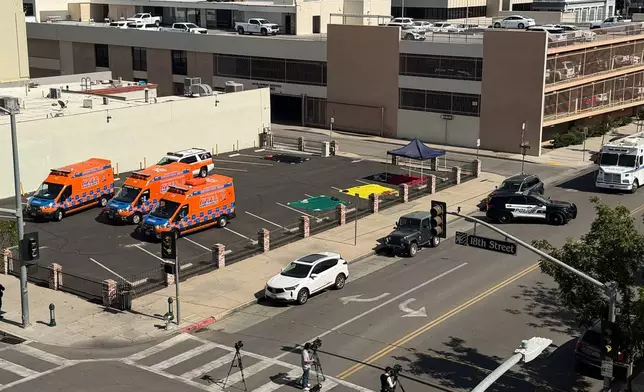 An overhead view shows police and media responding after a man barricaded himself inside a bank on Tuesday, June 2, 2026, in Bakersfield, Calif. (Jacob, Dad’s Gone Live via AP)