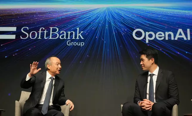 Masayoshi Son, left, chairman and CEO of SoftBank Group, speaks as Mark Chen, chief research officer for OpenAI, listens during a talk at their business event at a hotel in Tokyo, Tuesday, June 16, 2026. (AP Photo/Hiro Komae)