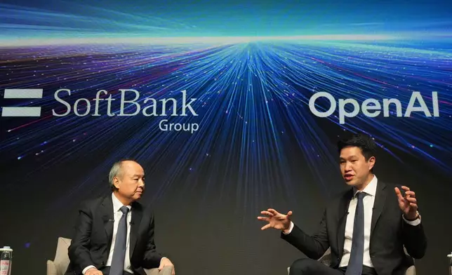 Masayoshi Son, left, chairman and CEO of SoftBank Group, listens to Mark Chen, chief research officer for OpenAI, during a talk at their business event in Tokyo, Tuesday, June 16, 2026. (AP Photo/Hiro Komae)