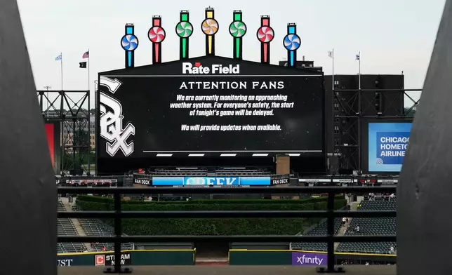 Information about rain delay displays on the big screen during a rain delay before a baseball game between the Atlanta Braves and the Chicago White Sox in Chicago, Thursday, June 11, 2026. (AP Photo/Nam Y. Huh)