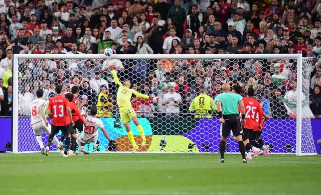 Egypt goalkeeper Mostafa Shoubir (23) jumps to save a shot at goal during the World Cup Group G soccer match between Egypt and Iran in Seattle, Friday, June 26, 2026. (AP Photo/Manu Fernandez)