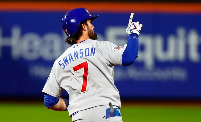 Chicago Cubs' Dansby Swanson (7) reacts while running the bases after hitting a two-run home run against the New York Mets during the fourth inning of a baseball game, Tuesday, June 23, 2026, in New York. (AP Photo/Noah K. Murray)