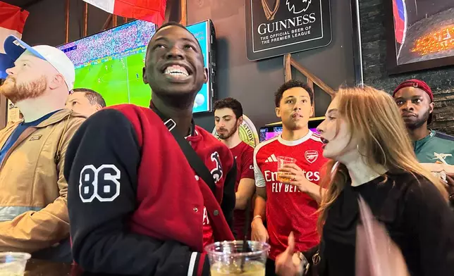 Fans watch a Champion league soccer match between Arsenal and Paris Saint-Germain at the Lion Sports Bar, Saturday, May 30, 2026, in Philadelphia. (AP Photo/Tassanee Vejpongsa)
