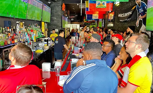 Fans watch a Champion league soccer match between Arsenal and Paris Saint-Germain at the Lion Sports Bar, Saturday, May 30, 2026, in Philadelphia. (AP Photo/Tassanee Vejpongsa)