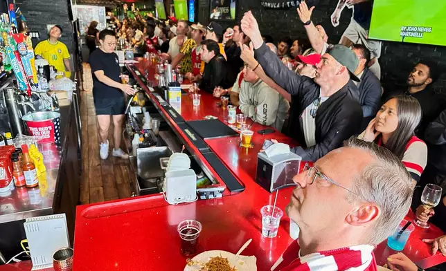 Fans watch a Champion league soccer match between Arsenal and Paris Saint-Germain at the Lion Sports Bar, Saturday, May 30, 2026, in Philadelphia. (AP Photo/Tassanee Vejpongsa)