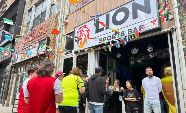 Fans arrive to watch a Champion league soccer match between Arsenal and Paris Saint-Germain at the Lion Sports Bar, Saturday, May 30, 2026, in Philadelphia. (AP Photo/Tassanee Vejpongsa)