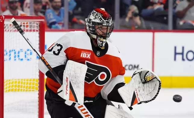 FILE - Philadelphia Flyers goaltender Samuel Ersson puts his glove out for a save during an NHL hockey game against the Montréal Canadiens, April 14, 2026, in Philadelphia. (AP Photo/Derik Hamilton, File)