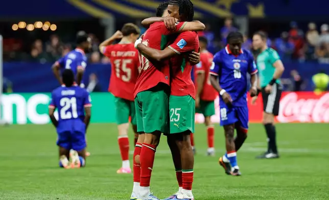 Morocco's Chadi Riad (18) and Redouane Halhal (25) celebrate the team's win during the World Cup Group C soccer match between Morocco and Haiti in Atlanta, Wednesday, June 24, 2026. (AP Photo/Erik S. Lesser)
