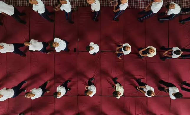 Students perform yoga during an event to mark International Yoga Day in Guwahati, India, Sunday, June 21, 2026. (AP Photo/Anupam Nath)